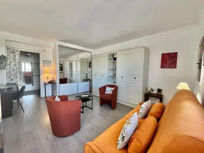 a living room with a couch and a dining room at Le Petit Magellan by Welcome to Cannes in Cannes