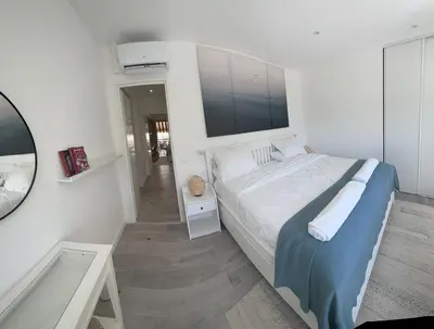 a white bedroom with a bed and a bath tub at Luxurious 3Bedroom 2 BATH 110 m Apartment Adjoining Hotel Martinez Beachfront in Cannes
