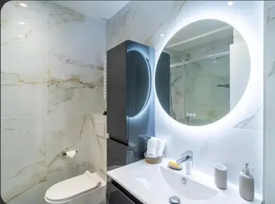 a bathroom with a sink and a mirror at Luxurious 3Bedroom 2 BATH 110 m Apartment Adjoining Hotel Martinez Beachfront in Cannes