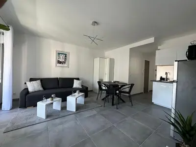 a living room with a couch and a table at Appartement cosy à 2 pas de la Croisette in Cannes
