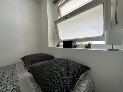 a bedroom with two pillows and a window at Appartement cosy à 2 pas de la Croisette in Cannes