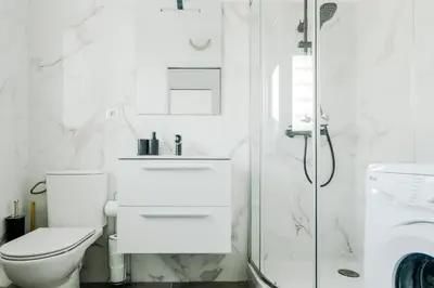 a white bathroom with a toilet and a shower at Appartement cosy à 2 pas de la Croisette in Cannes