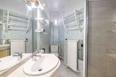 a bathroom with a sink and a toilet at LE CONNEMARRA avec balcon, lumineux et calme à côté du centre in Cannes