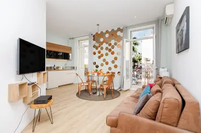 a living room with a couch and a table at Nasturtium YourHostHelper in Cannes