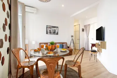 a living room with a table with fruit on it at Nasturtium YourHostHelper in Cannes