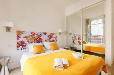 a bedroom with a large bed with towels on it at Nasturtium YourHostHelper in Cannes