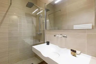 a bathroom with a sink and a shower at Nasturtium YourHostHelper in Cannes