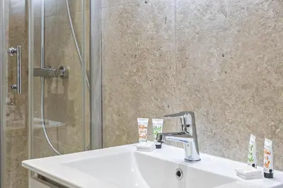 a bathroom with a sink and a shower at LE LOGIS CANNOIS au calme en centre-ville in Cannes