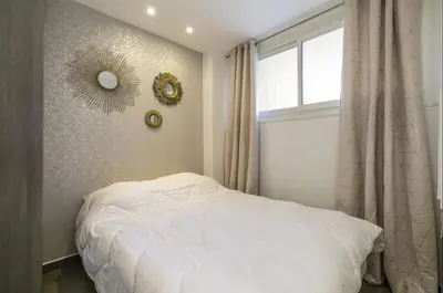 a bedroom with a white bed and a window at Superbe T2 lumineux dans le centre CIO1899 in Cannes