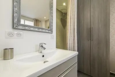 a bathroom with a white sink and a mirror at Superbe T2 lumineux dans le centre CIO1899 in Cannes