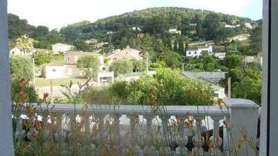 a view of a city from a house with a fence at Bas de villa prestations haut de gamme in Vallauris