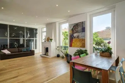 a living room with a table and a fireplace at Good sleeping in Cannes