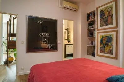 a bedroom with a red bed and a window at Good sleeping in Cannes