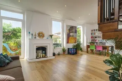 a living room with a fireplace and a dining room at Good sleeping in Cannes