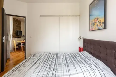 a bedroom with a bed with a white bedspread at Cannes, charmant 3 pièces proche centre et plages in Cannes