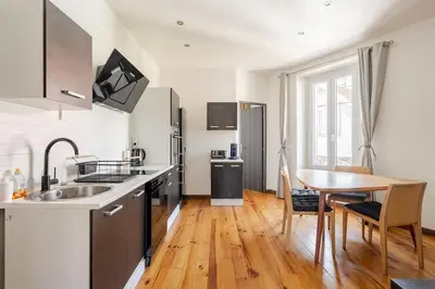a kitchen with a sink and a table at Cannes, charmant 3 pièces proche centre et plages in Cannes