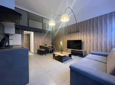 a living room with a blue couch and a table at Cannes, Loft 6 couchages proche centre et plages in Cannes