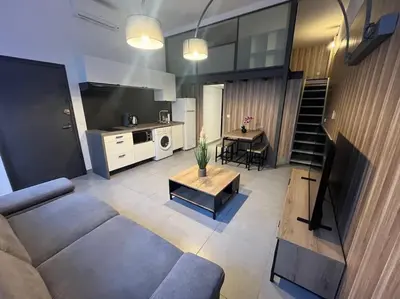 a living room with a couch and a table at Cannes, Loft 6 couchages proche centre et plages in Cannes