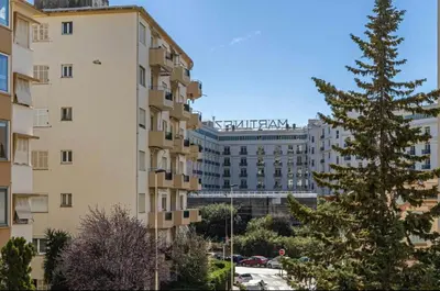 a tall building with a christmas tree in front of it at CANNES 2 P avec terrasse PROCHE Hôtel Martinez in Cannes
