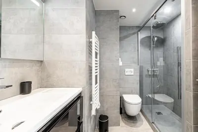 a bathroom with a sink and a toilet and a shower at CANNES 2 P avec terrasse PROCHE Hôtel Martinez in Cannes
