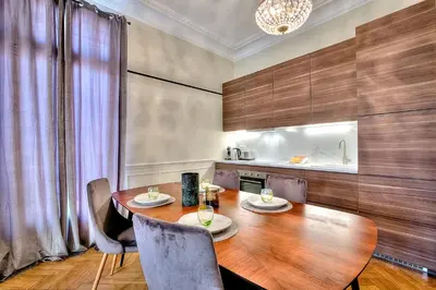 a dining room with a wooden table and chairs at FAR5 - 3 chambres à deux pas de la rue d'Antibes in Cannes
