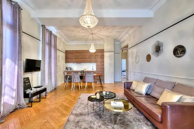 a living room with a couch and a table at FAR5 - 3 chambres à deux pas de la rue d'Antibes in Cannes