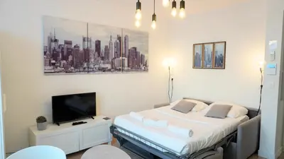 a bedroom with a bed and a tv in it at Proche Carlton & Croisette, Appartement 303 in Cannes