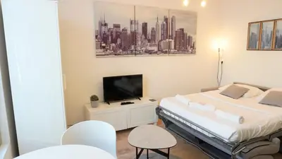 a bedroom with two beds and a tv on a cabinet at Proche Carlton & Croisette, Appartement 303 in Cannes