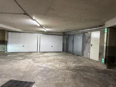 an empty room with white garage doors in a building at Proche Carlton & Croisette, Appartement 303 in Cannes