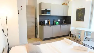 a living room with a kitchen and a table at Proche Carlton & Croisette, Appartement 303 in Cannes