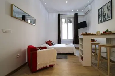 a living room with a bed and a couch and a table at Le Borniol ! Idéal ! Congrès! Central! lumineux! in Cannes