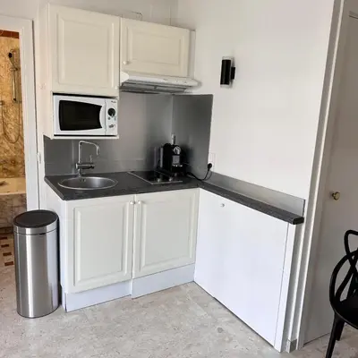 a small kitchen with a sink and a microwave at 2P Between Croisette Beaches and Antibes Street in Cannes