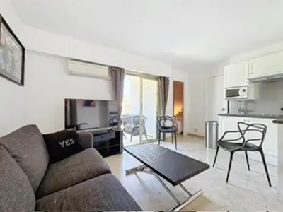 a living room with a couch and a table at 2P Between Croisette Beaches and Antibes Street in Cannes
