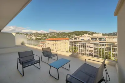 a balcony with three chairs and a table on it at Coco - Spacieux - Luxueux - VCA in Cannes