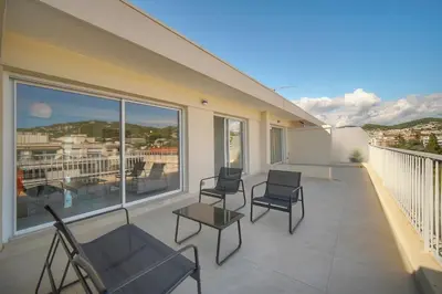 a balcony with chairs and a table on a building at Coco - Spacieux - Luxueux - VCA in Cannes