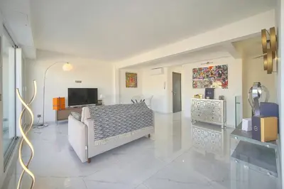 a bedroom with a bed and a television in it at Coco - Spacieux - Luxueux - VCA in Cannes