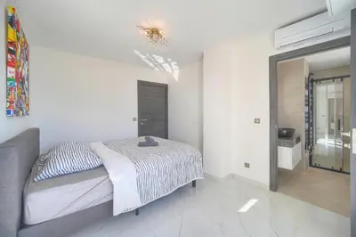 a bedroom with a bed in a white room at Coco - Spacieux - Luxueux - VCA in Cannes
