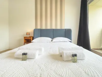 a large white bed with towels on top of it at Le Montfleury by Winsome Destination in Cannes