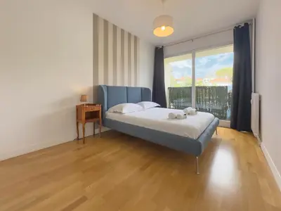 a bedroom with a bed and a large window at Le Montfleury by Winsome Destination in Cannes