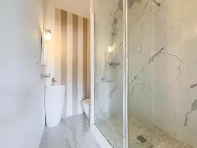 a bathroom with a toilet and a glass shower at Le Montfleury by Winsome Destination in Cannes