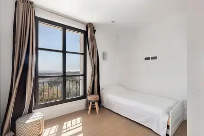 a bedroom with a bed and a large window at Villa avec piscine à Cannes 7 bedrooms in Le Cannet