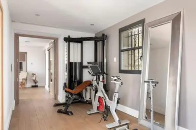 a gym with two exercise bikes and a mirror at Villa avec piscine à Cannes 7 bedrooms in Le Cannet