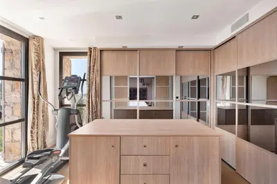 a kitchen with wooden cabinets and a treadmill at Villa avec piscine à Cannes 7 bedrooms in Le Cannet