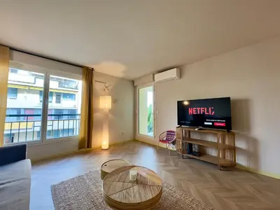 a living room with a television and a table at Le Montébello By SCLS Locations in Cannes