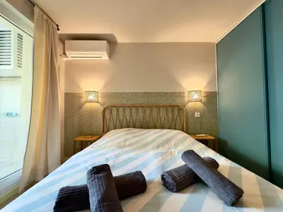 a bedroom with a bed with two logs on it at Le Montébello By SCLS Locations in Cannes
