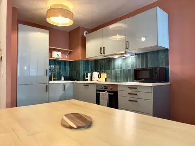 a kitchen with a wooden table with a wooden bowl on it at Le Montébello By SCLS Locations in Cannes