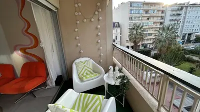 a balcony with two chairs and a table on a balcony at Charmant studio Croisette in Cannes