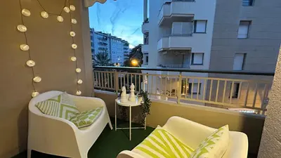 a balcony with two chairs and a table on a building at Charmant studio Croisette in Cannes