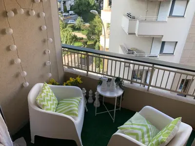 a balcony with two chairs and a table at Charmant studio Croisette in Cannes
