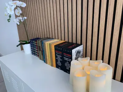 a table with books and candles on a table at Charmant studio Croisette in Cannes
